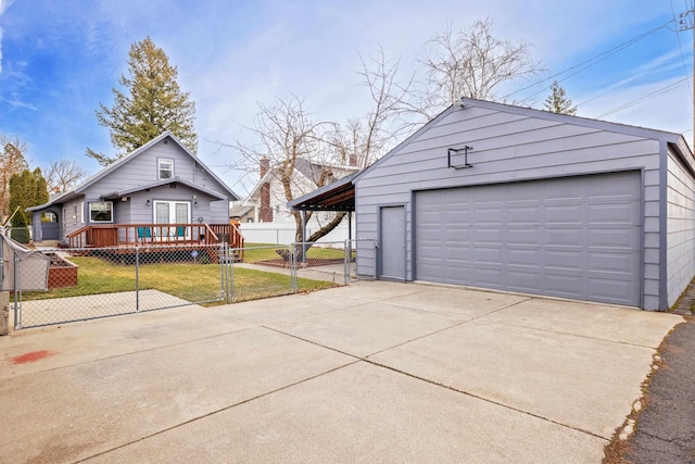 detached garage with a gate and fence