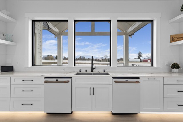 kitchen featuring light wood-type flooring, tasteful backsplash, range hood, white appliances, and white cabinets