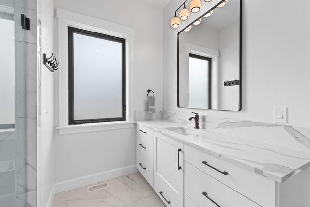 bathroom with a sink, baseboards, marble finish floor, and two vanities