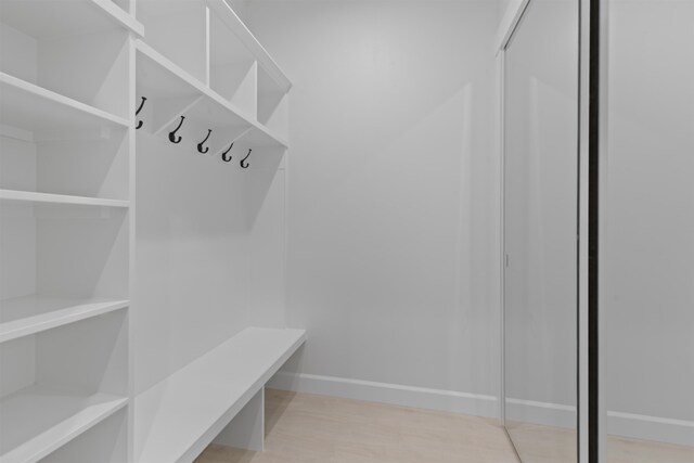 mudroom with baseboards and light wood finished floors