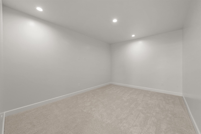 empty room with recessed lighting, baseboards, and light carpet