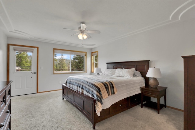 bedroom with light carpet, ceiling fan, and baseboards