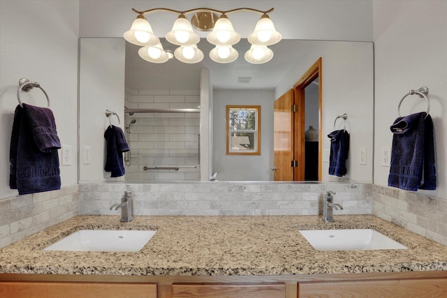 full bath featuring double vanity, decorative backsplash, a shower stall, and a sink