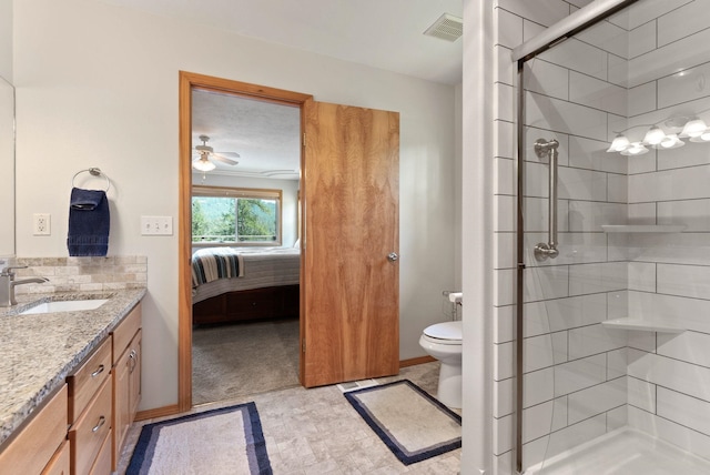 ensuite bathroom featuring visible vents, toilet, a stall shower, ensuite bath, and vanity