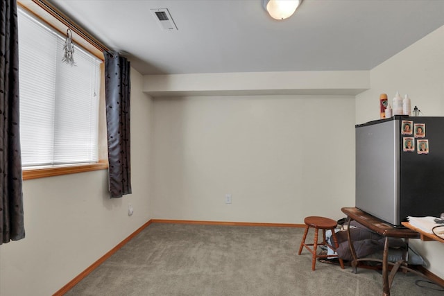 living area with visible vents, baseboards, and carpet floors