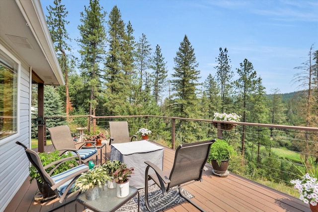 wooden terrace with a forest view