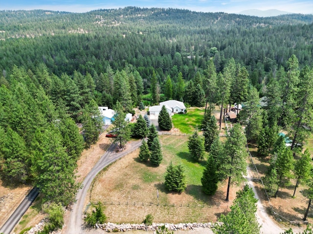 birds eye view of property featuring a view of trees