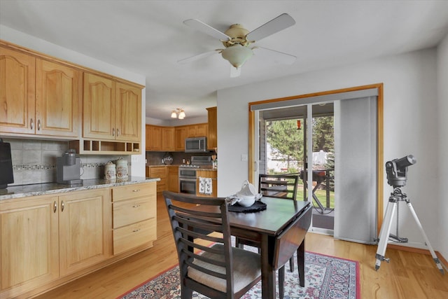 dining area with a ceiling fan, baseboards, and light wood finished floors