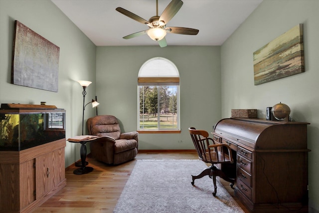 office with light wood-style flooring, baseboards, and a ceiling fan