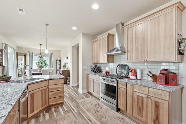 kitchen with visible vents, a sink, light brown cabinetry, appliances with stainless steel finishes, and wall chimney range hood