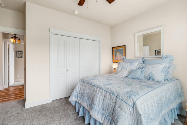 carpeted bedroom featuring a closet, a ceiling fan, and baseboards