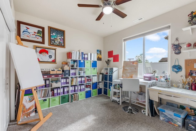 home office with carpet, visible vents, and ceiling fan