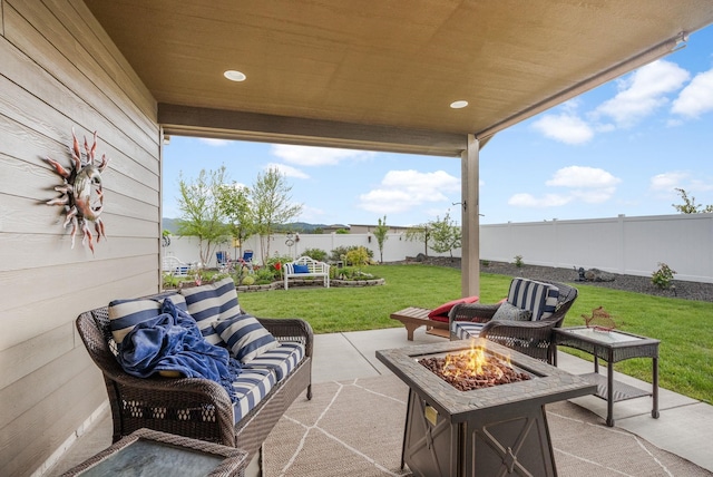 view of patio featuring an outdoor living space with a fire pit and a fenced backyard