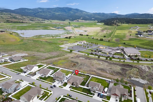 birds eye view of property with a residential view and a water and mountain view