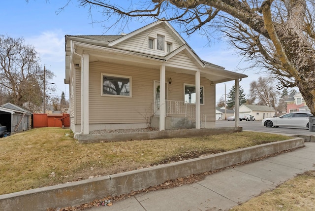 bungalow-style house with a porch and a front yard