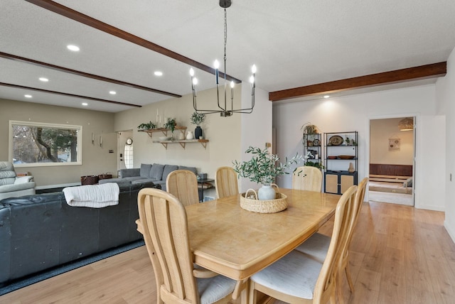 dining space with beamed ceiling, recessed lighting, a textured ceiling, and light wood-type flooring