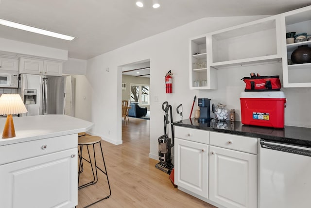 kitchen with open shelves, white cabinetry, stainless steel fridge, white microwave, and dishwasher