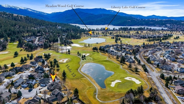 bird's eye view featuring a residential view, a mountain view, and view of golf course