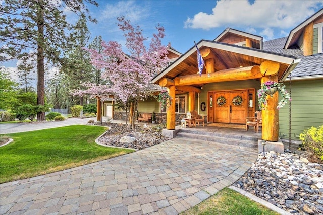 view of front of property with a front yard and a shingled roof