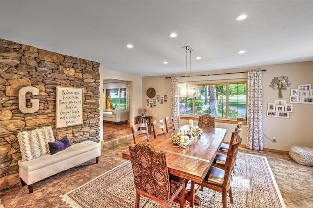 dining room featuring recessed lighting, baseboards, and arched walkways