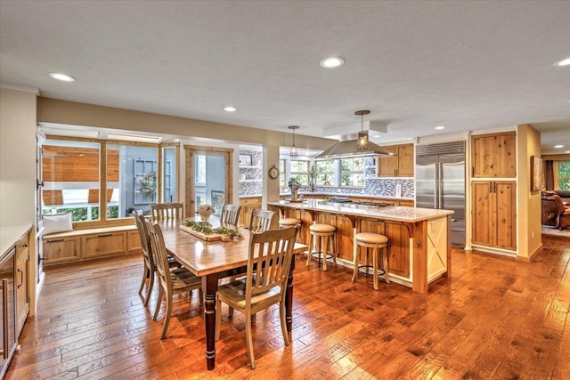 dining space featuring a wealth of natural light, recessed lighting, and dark wood-type flooring