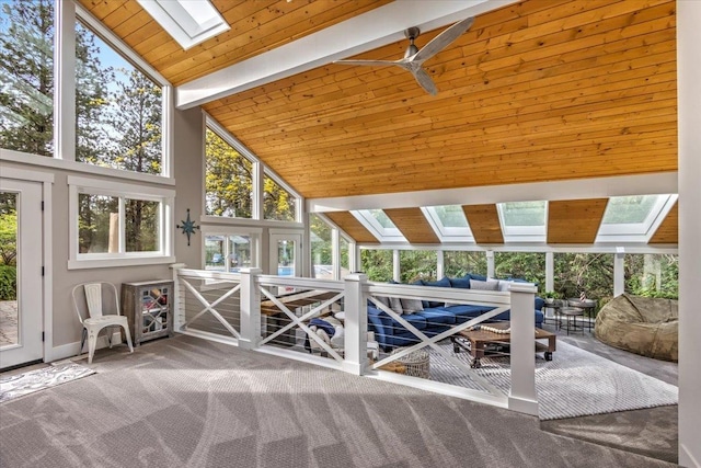 unfurnished sunroom with vaulted ceiling with skylight and wooden ceiling