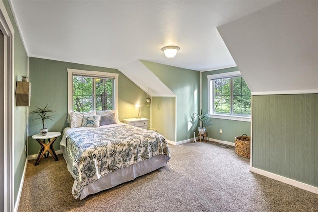 bedroom with baseboards, lofted ceiling, and carpet floors