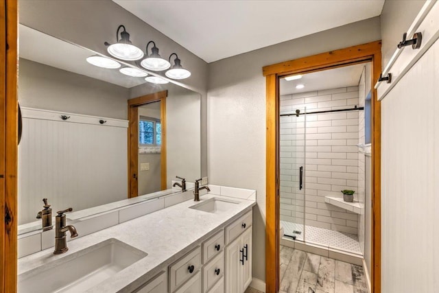 bathroom featuring a shower stall and a sink