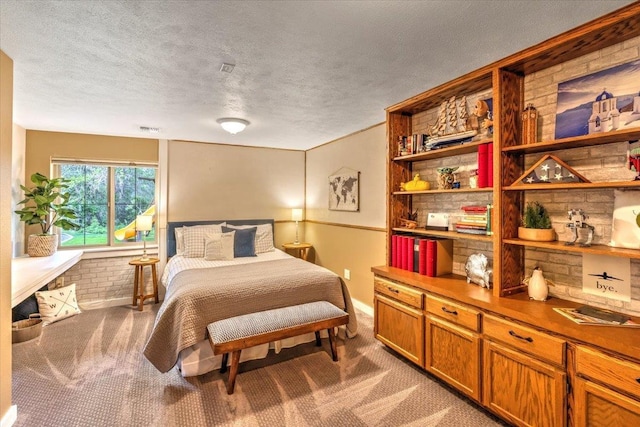 carpeted bedroom featuring visible vents and a textured ceiling