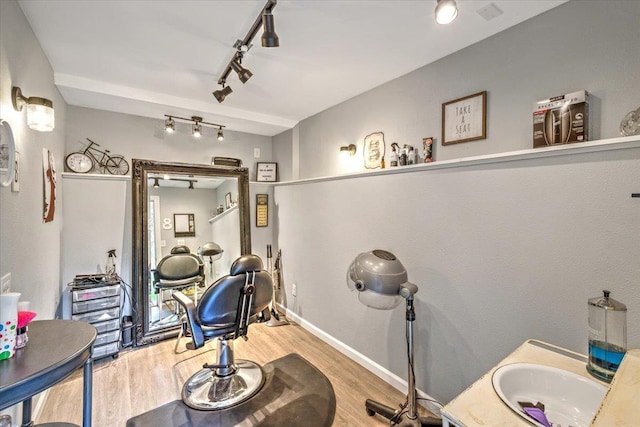 interior space with vanity, baseboards, and wood finished floors