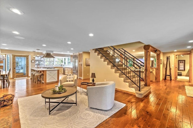 living area with light wood finished floors, stairway, recessed lighting, and baseboards