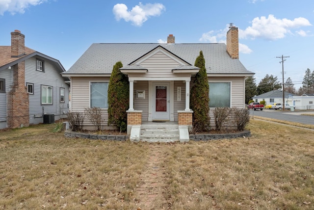 view of front of home featuring a front lawn and a chimney