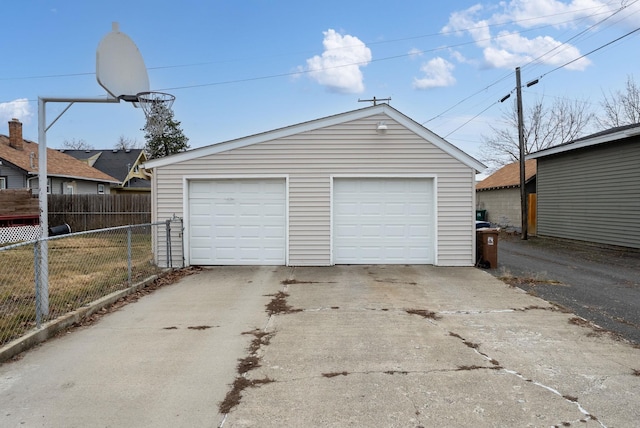 detached garage featuring fence