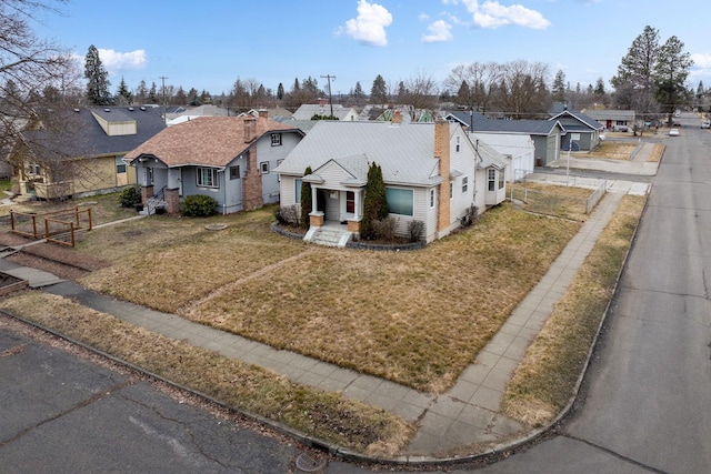 bungalow with a front yard, fence, and a residential view