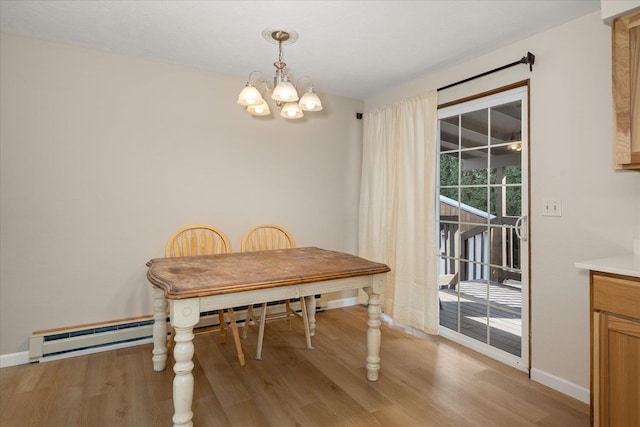 dining room with a notable chandelier, light wood-style flooring, and baseboards