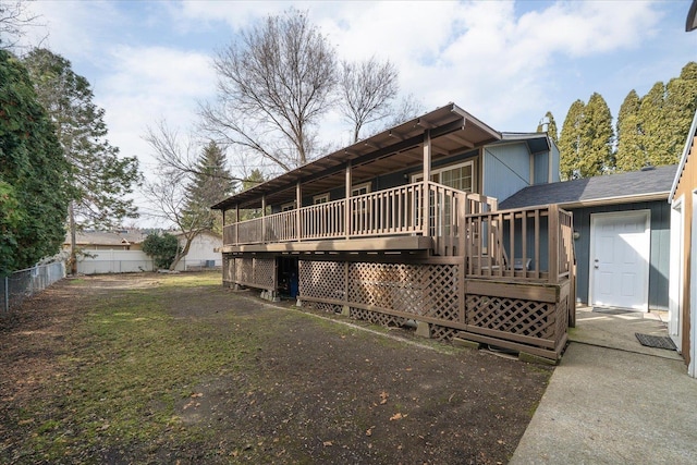 back of house with a deck and fence