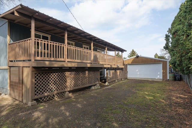 rear view of property with a detached garage and an outdoor structure