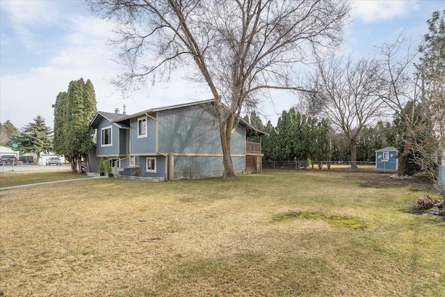 view of yard featuring an outdoor structure and fence