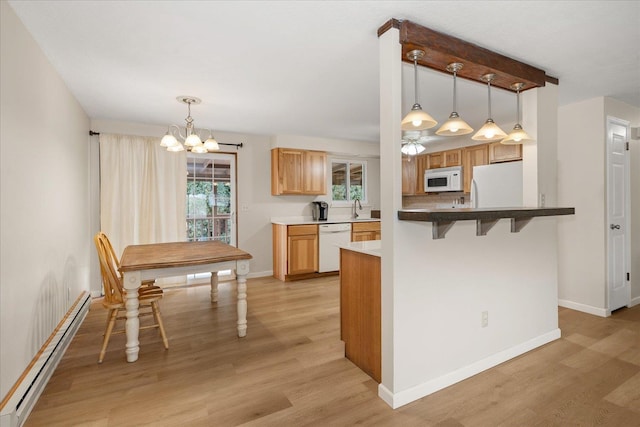 kitchen with light wood finished floors, baseboards, a baseboard radiator, white appliances, and a sink