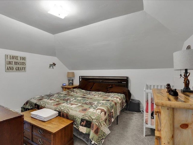 carpeted bedroom featuring vaulted ceiling