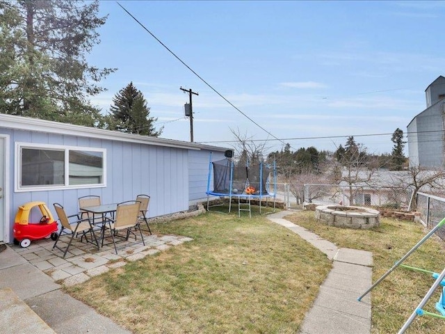 327 S Crosby St, Tekoa, WA 99033 - view of yard with a fire pit, a trampoline, and a patio
