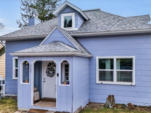 327 S Crosby St, Tekoa, WA 99033 - property entrance with a shingled roof and a chimney