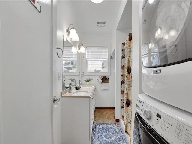 bathroom with curtained shower, vanity, and stacked washer and dryer