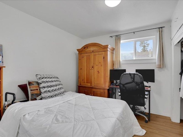 bedroom with baseboards and light wood-style floors