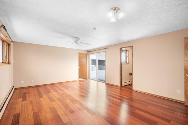 unfurnished room featuring a baseboard heating unit, ceiling fan, wood finished floors, a textured ceiling, and a baseboard radiator