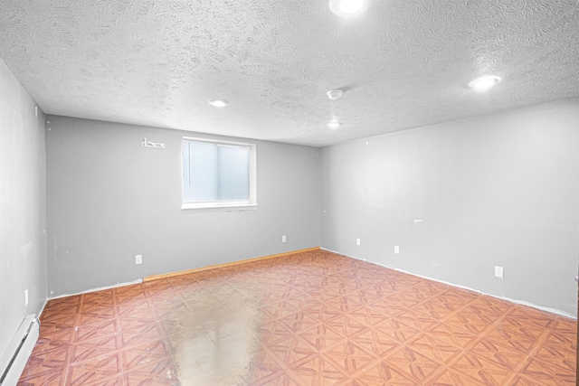 empty room featuring a textured ceiling, light floors, baseboards, and a baseboard radiator