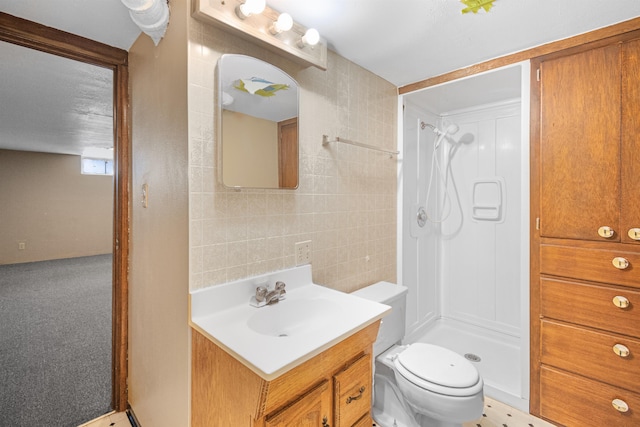 full bathroom featuring vanity, tile walls, toilet, and a stall shower