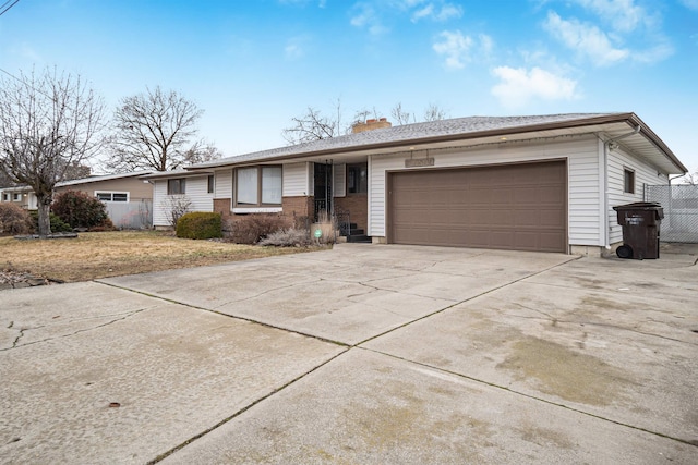 ranch-style home featuring driveway, fence, a garage, brick siding, and a chimney