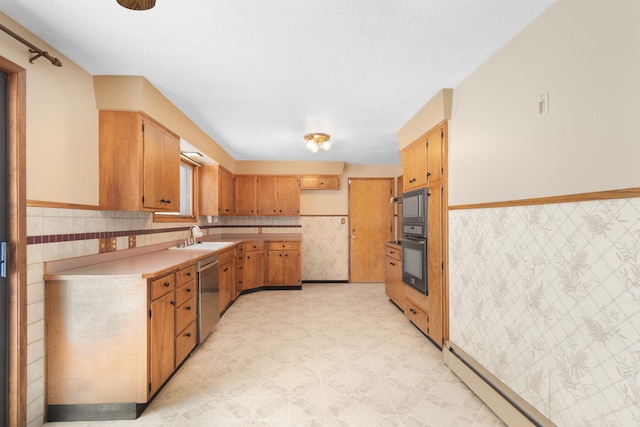 kitchen with light floors, light countertops, wainscoting, stainless steel dishwasher, and a baseboard radiator