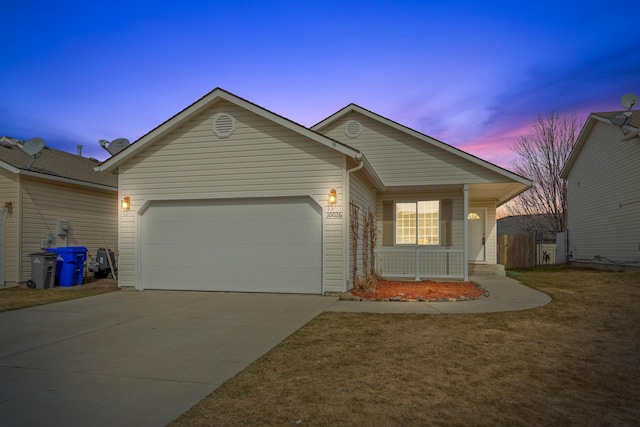 ranch-style home featuring concrete driveway, an attached garage, a porch, and a yard